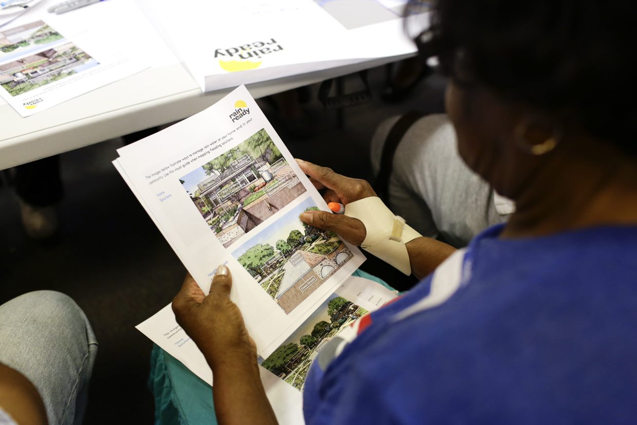 A woman reviewing Rain Ready documents at a table