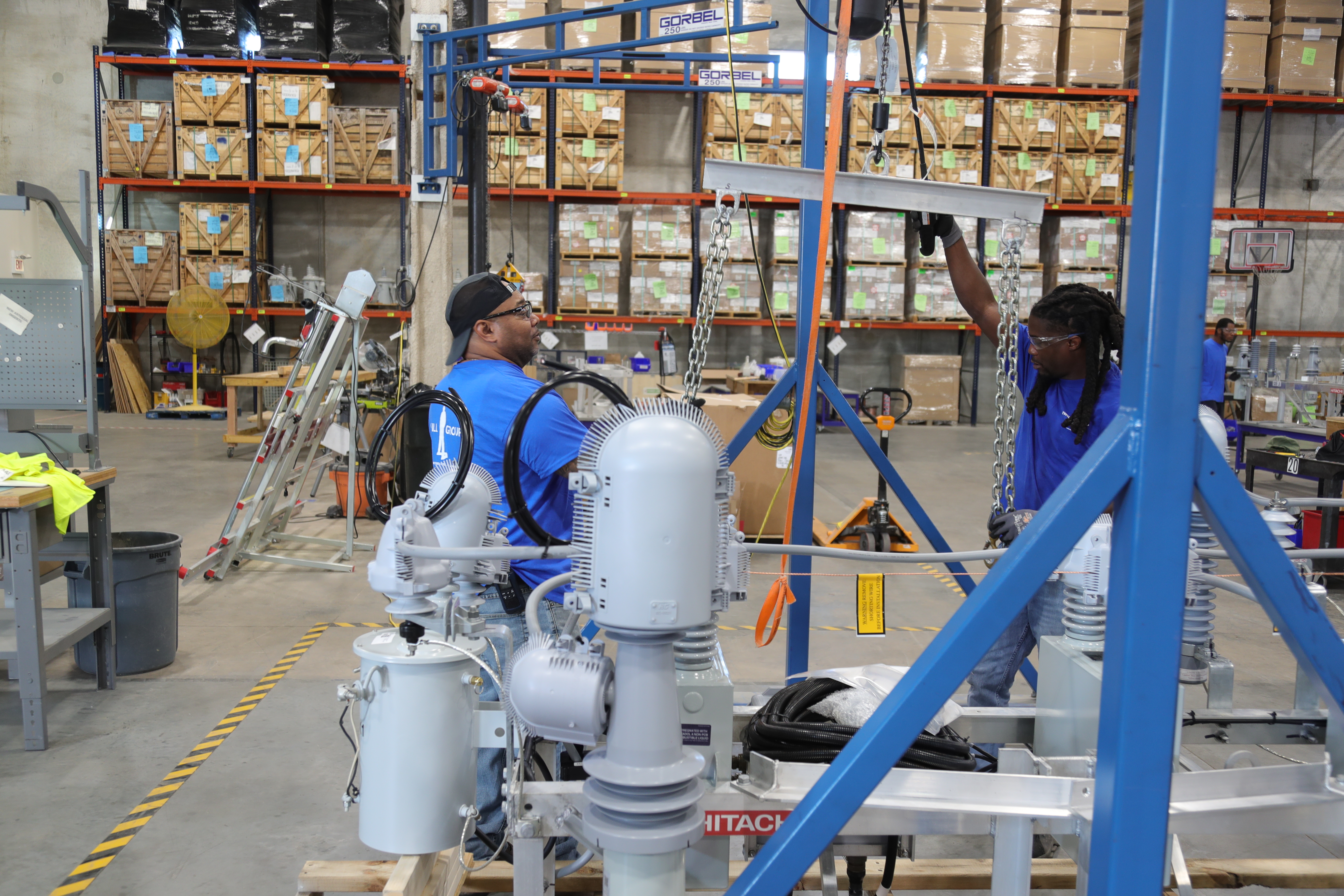 Two factor workers using equipment