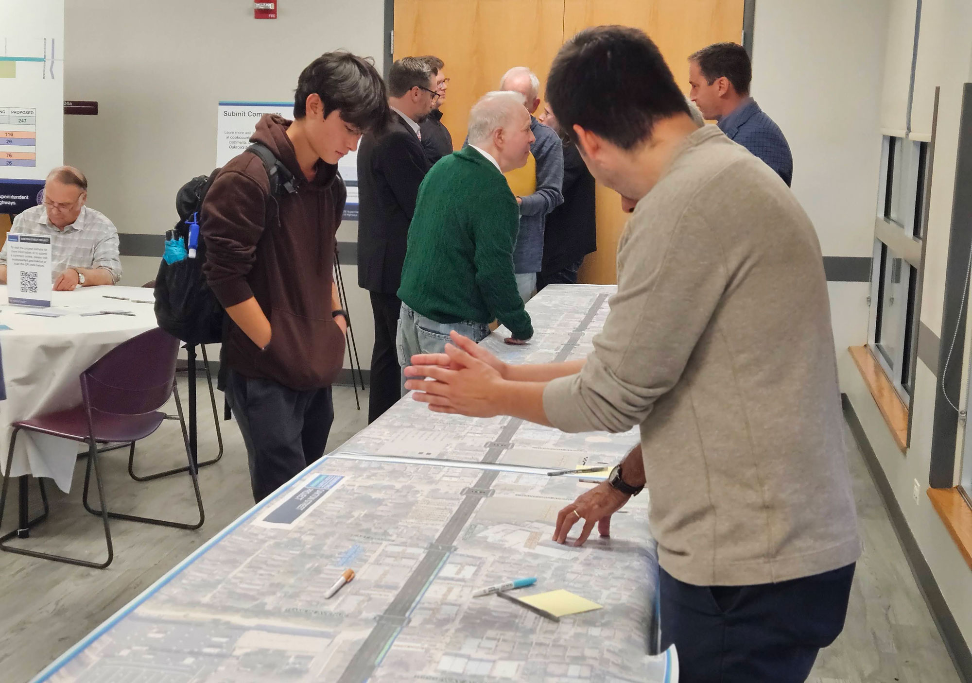 Residents look at maps at the Oct. 10, 2024, public meeting