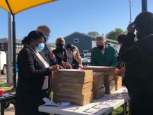 From left: HACC Executive Director Rich Monocchio, Robbins Mayor Tyrone Ward and President Preckwinkle distribute laptops to Flowers residents following the announcement on October 7, 2020.